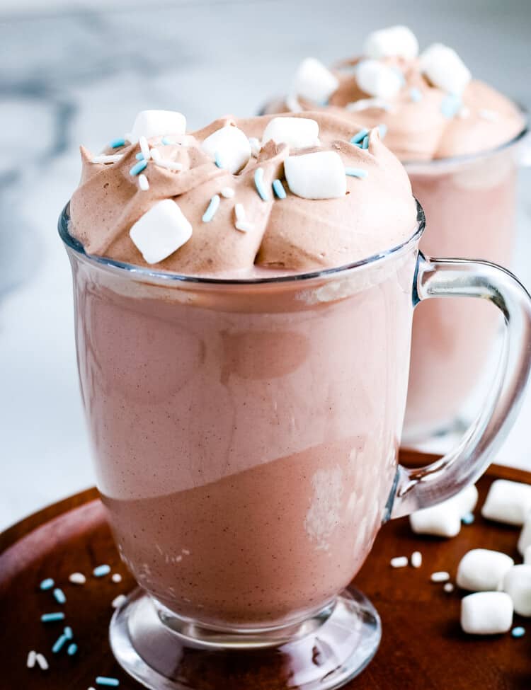 Mug full of Whipped Hot Chocolate topped with marshmallows and sprinkles