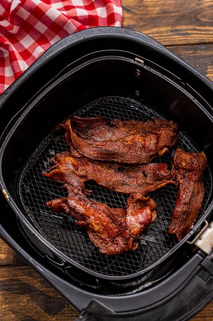 Cooked bacon in air fryer basket