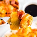 Air Fryer Hawaiian Kabobs on a fork. A piece of pineapple, ham and shrimp coated in BBQ Sauce.