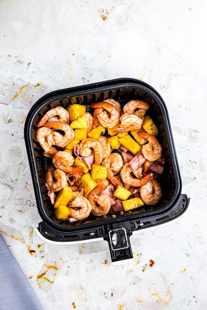 Cooked Hawaiian Shrimp mixture in air fryer basket.