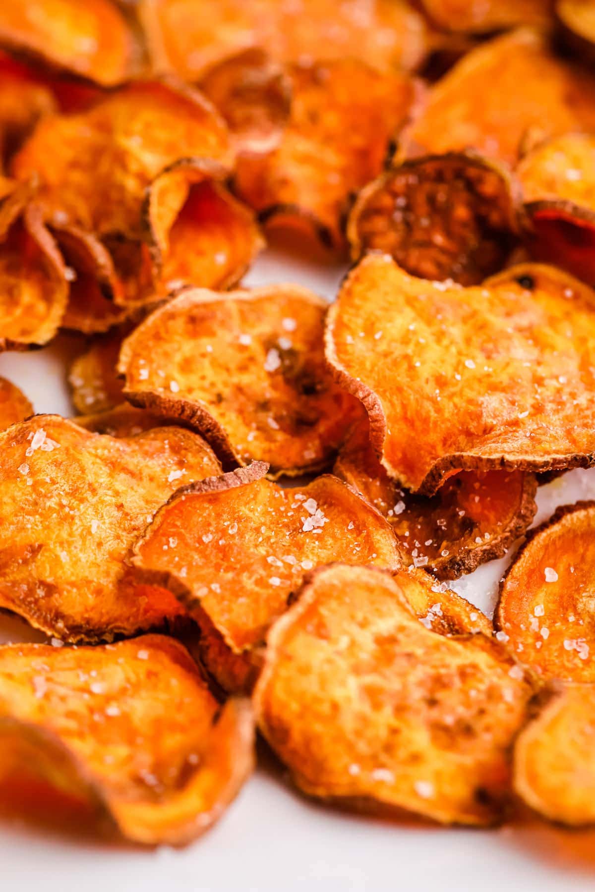 Close up of cooked Air Fryer Sweet Potato Chips seasoned with salt