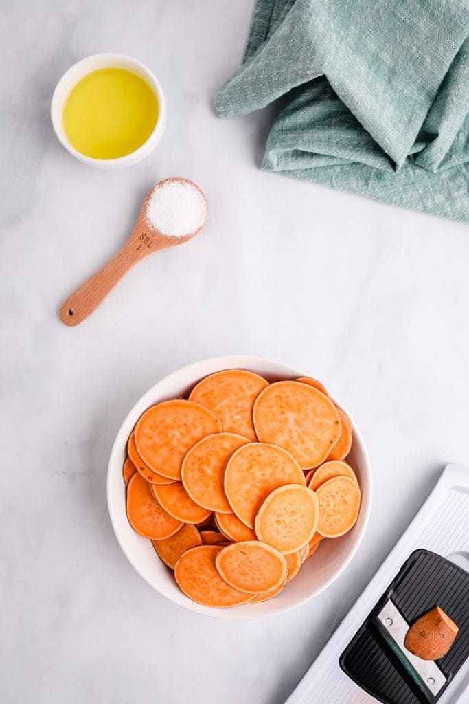 Thinly sliced sweet potatoes in white dish