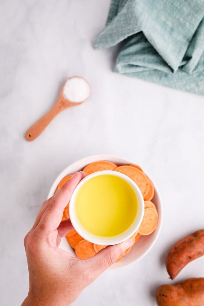 Oil in a small white dish before adding to sweet potatoes