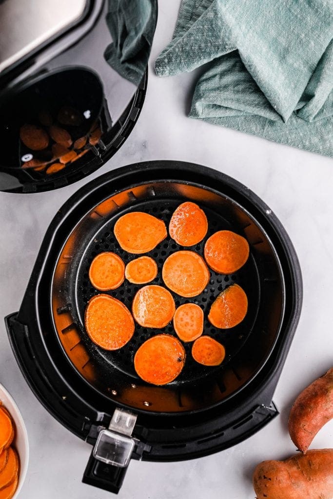 Sweet potatoes in air fryer basket before cooking