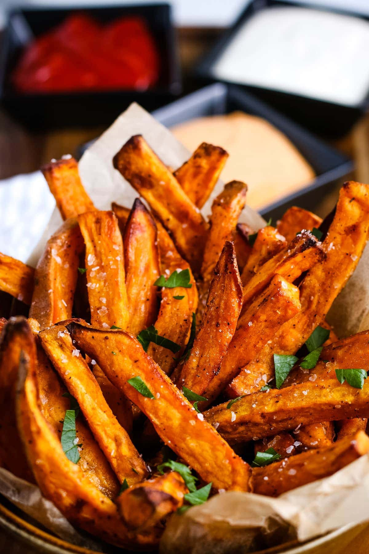 Air Fryer Sweet Potato Fries in a cup and garnished with parsley