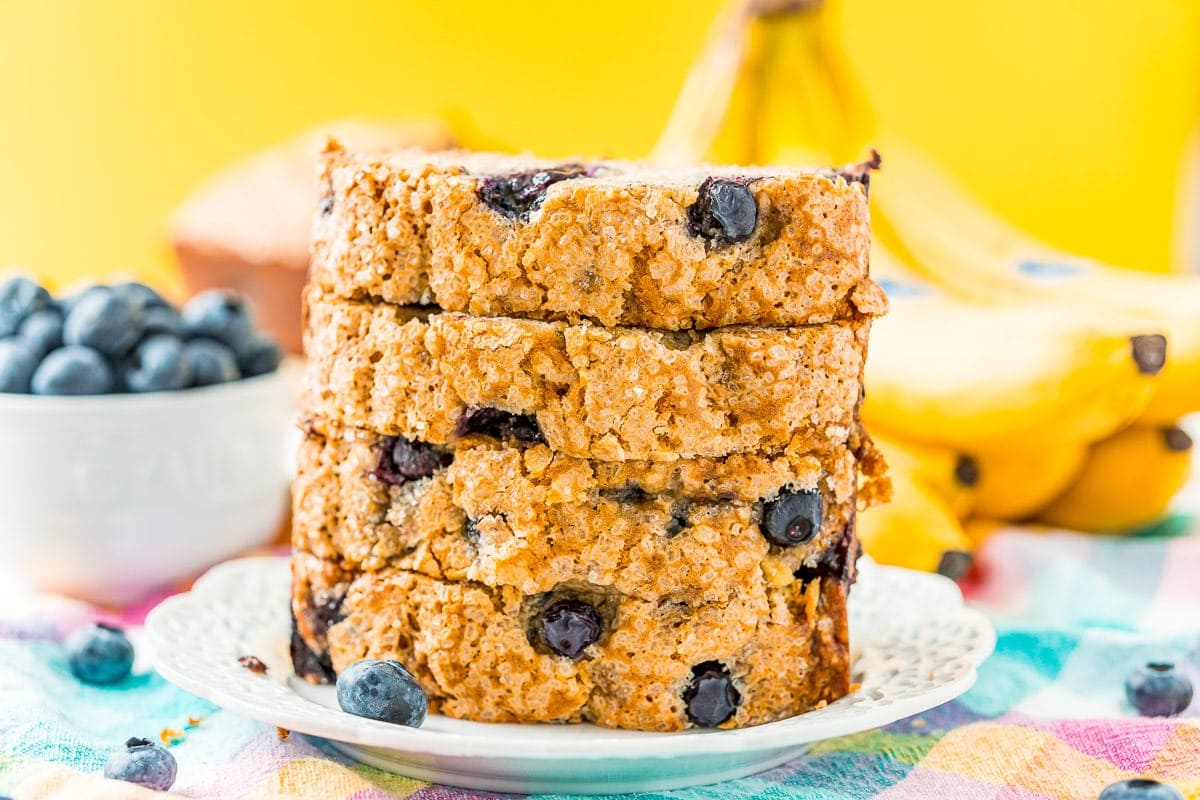 Blueberry Banana Bread sliced and stacked on a plate.