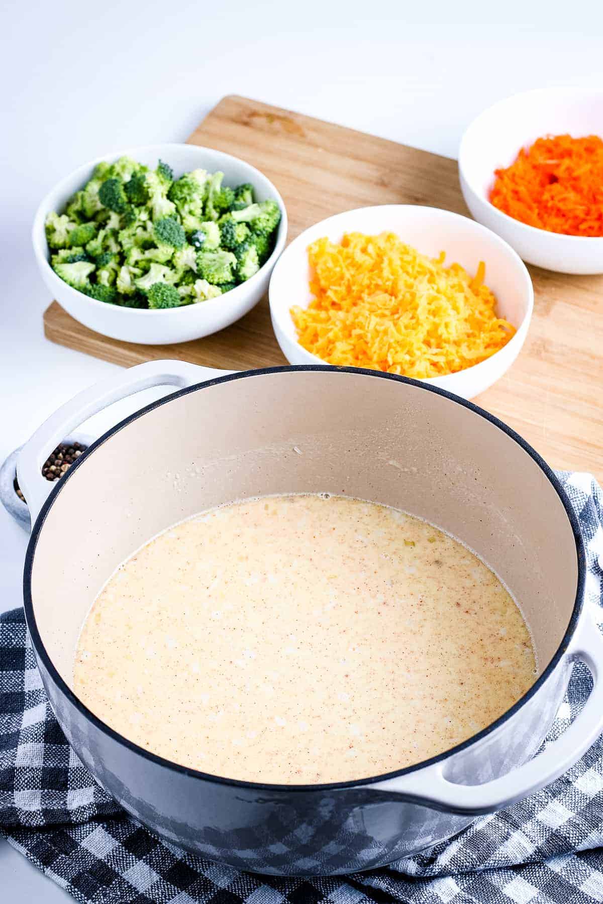 Dutch oven with soup base in it for Broccoli Cheese Soup