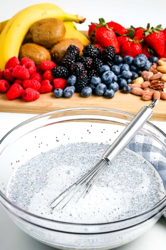 Glass bowl with ingredients to make chia pudding after mixing