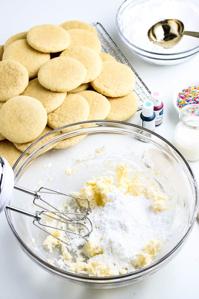 Frosting ingredients added to glass bowl.