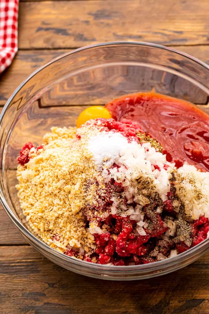 Glass bowl of ingredients for Italian meatloaf