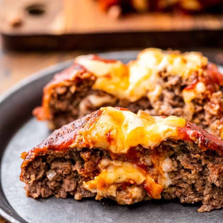 A plate with cheese stuffed Italian meatloaf on it.