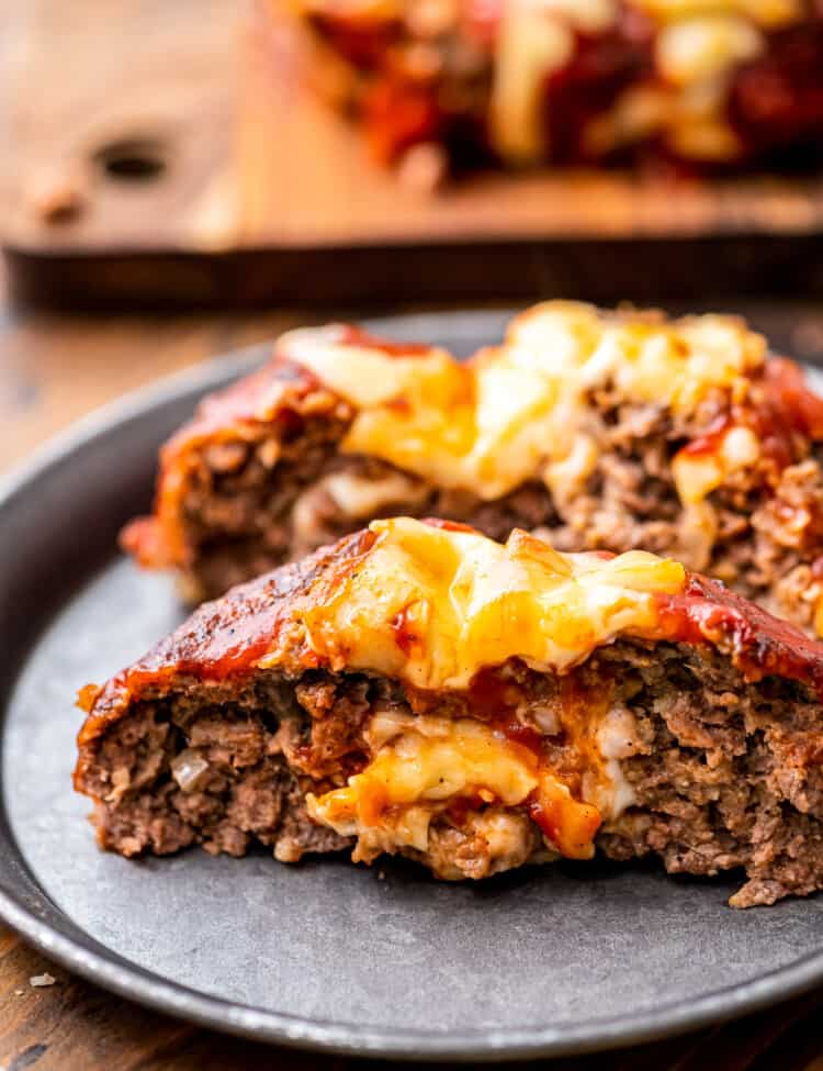 A plate with cheese stuffed Italian meatloaf on it.