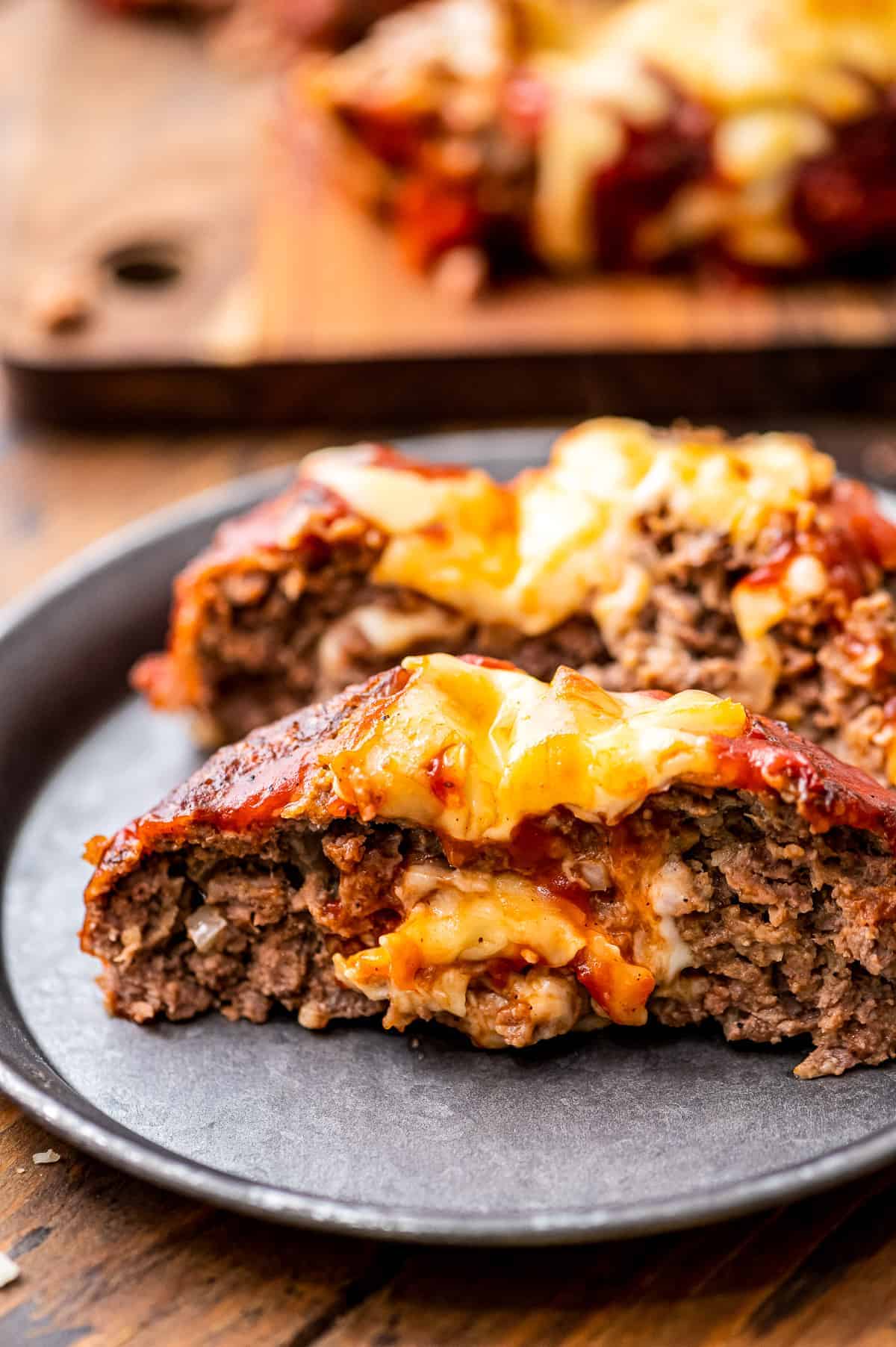 A plate with cheese stuffed Italian meatloaf on it.