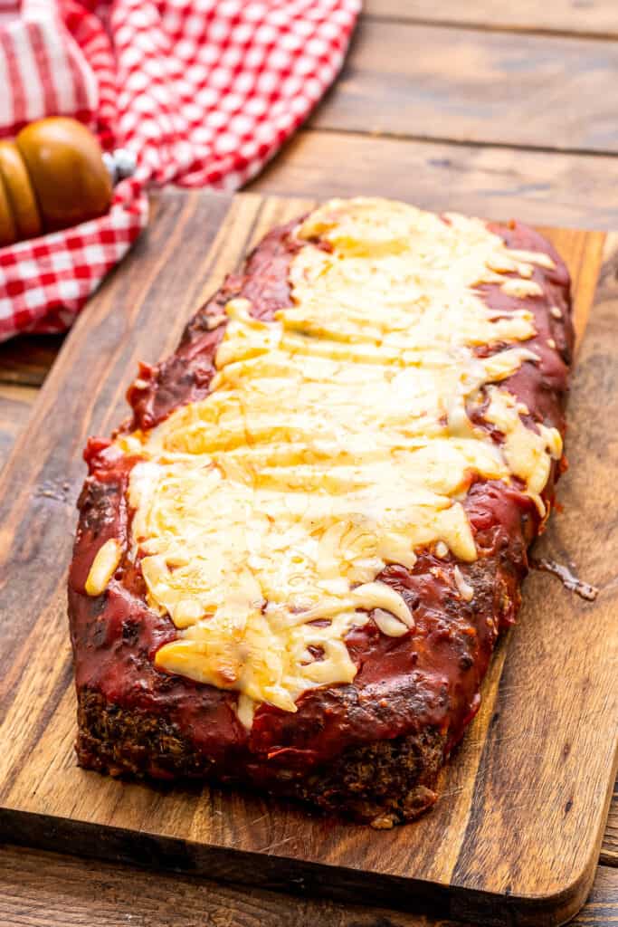 Baked Italian Meatloaf topped with tomato sauce and cheese