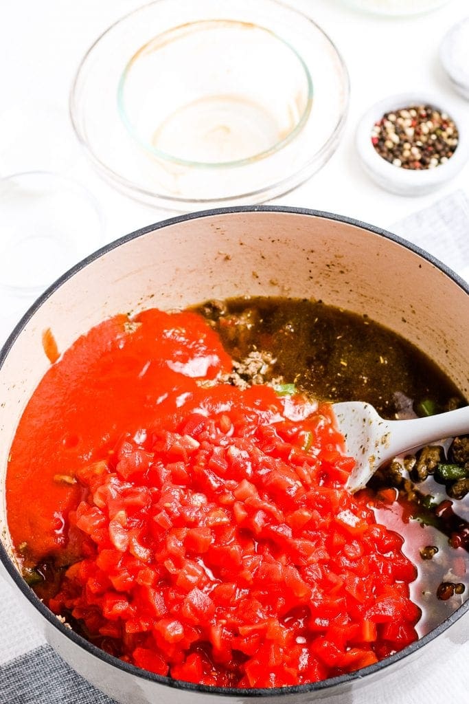 Dutch oven with ingredients for stuffed pepper soup before combining.