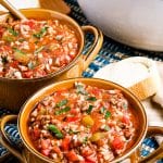 Stuffed Pepper Soup in brown bowls garnished with parsley.