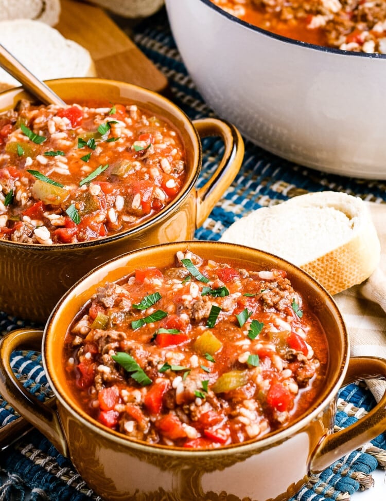 Stuffed Pepper Soup in brown bowls garnished with parsley.