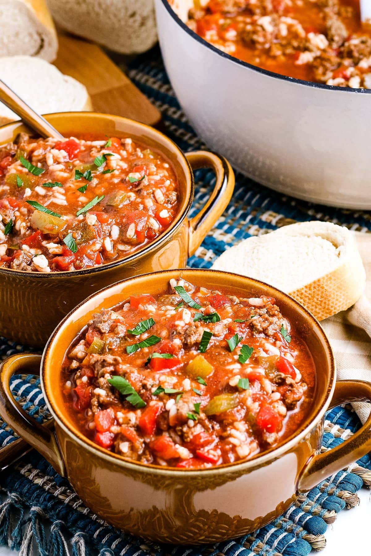 Stuffed Pepper Soup in brown bowls garnished with parsley.