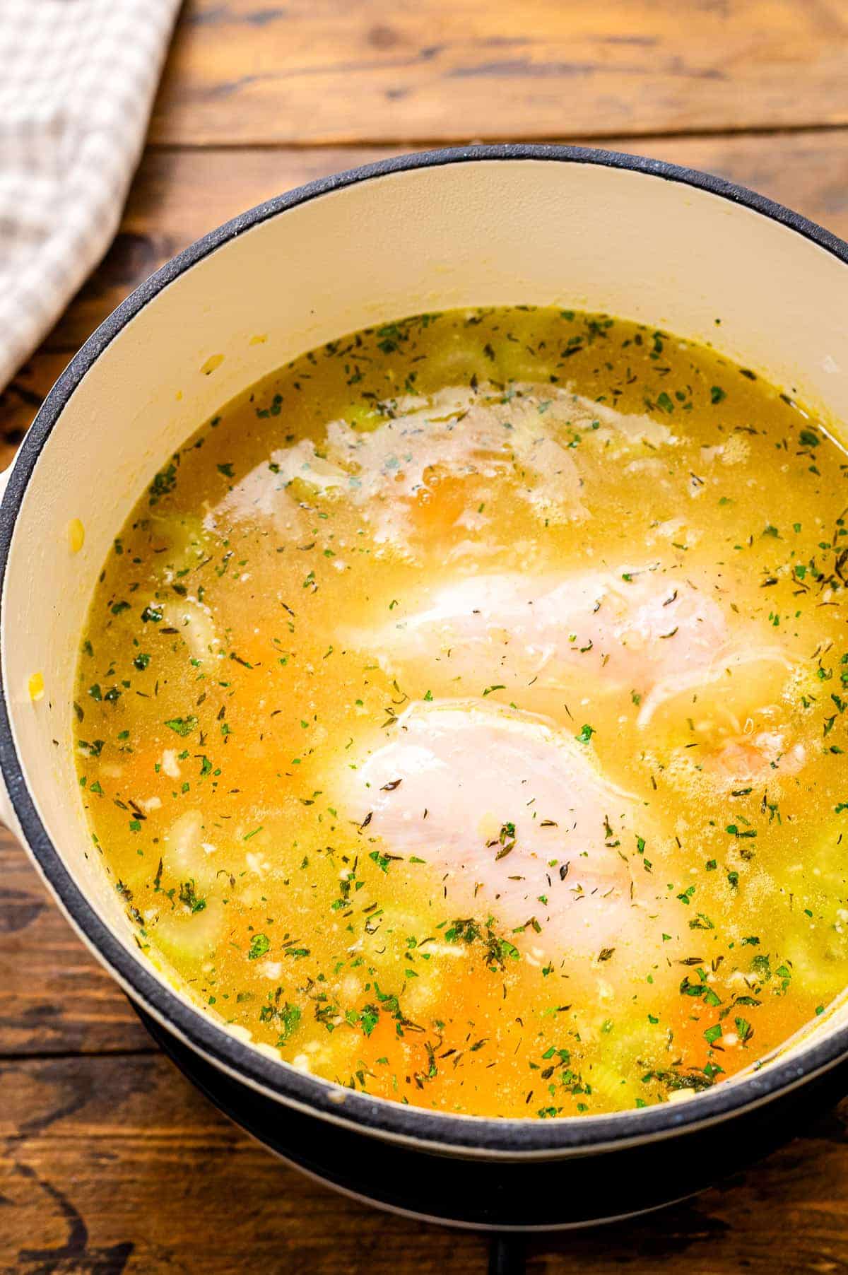 Dutch oven with simmering soup ingredients