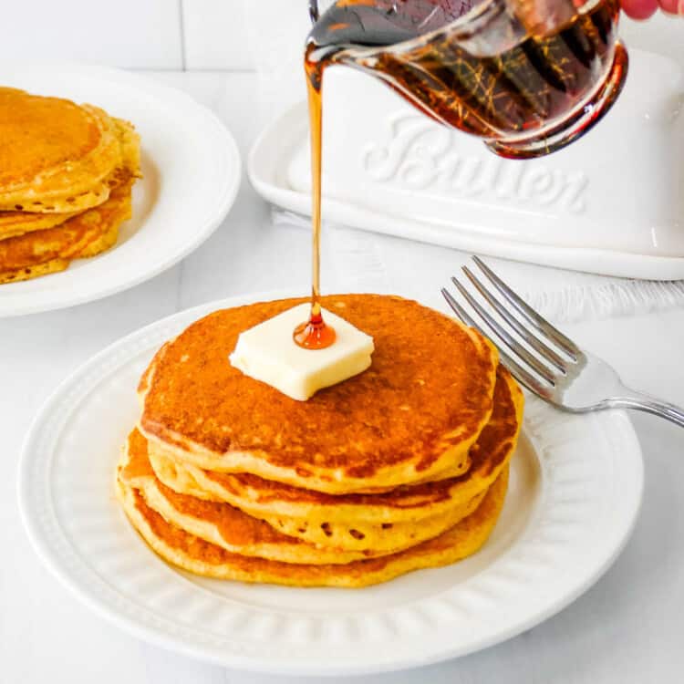 Cornmeal Pancakes Square cropped image of pancakes on white plate.