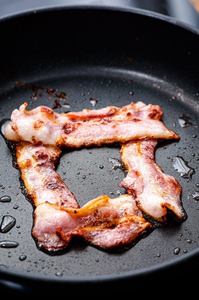 Frying pan with bacon making a shape of a square