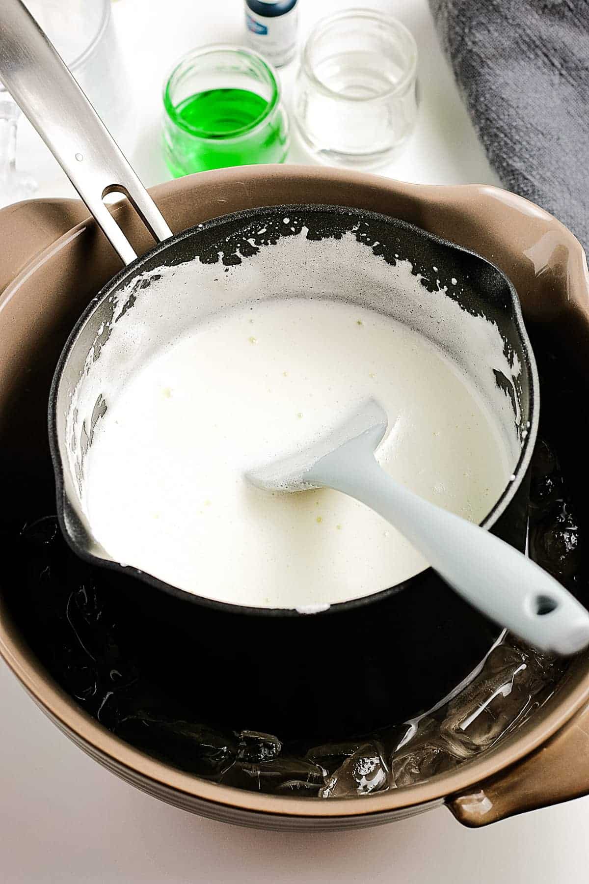 A saucepan with marshmallow filling in an ice water bath