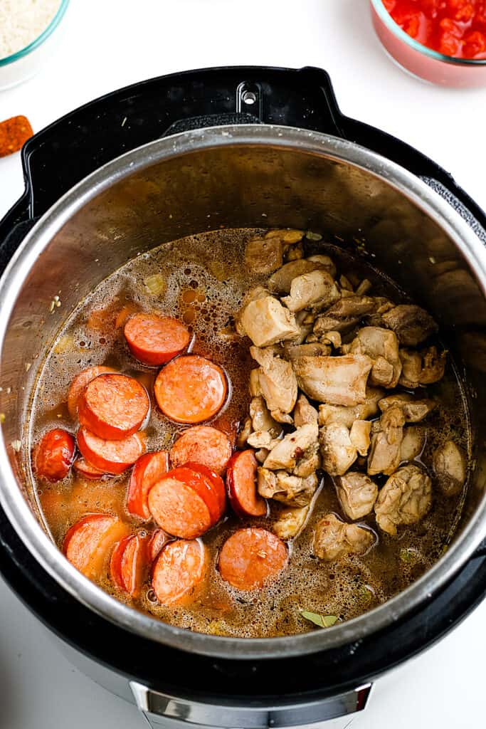 Instant Pot with sausage and chicken added for jambalaya