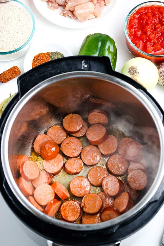 Instant Pot with sliced andouille sausage in it