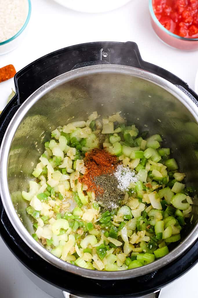 Celery, onions and seasonings in instant pot for jambalaya