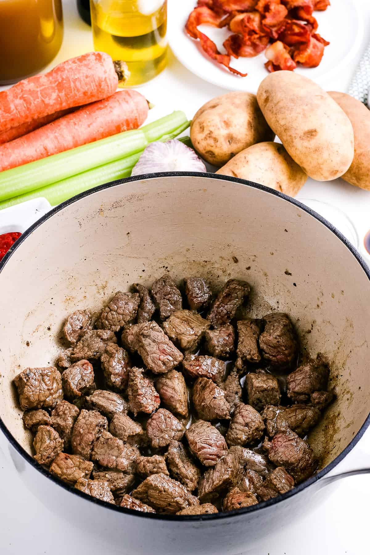 Dutch oven with browned stew meat in it