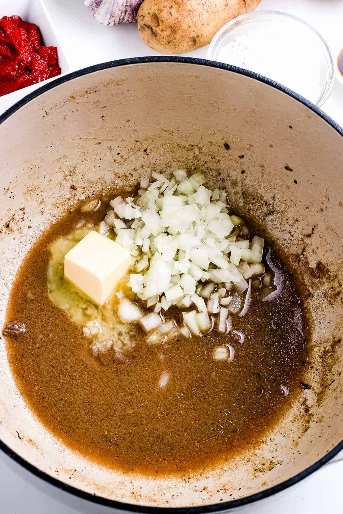 Butter and onions in dutch oven with beef drippings