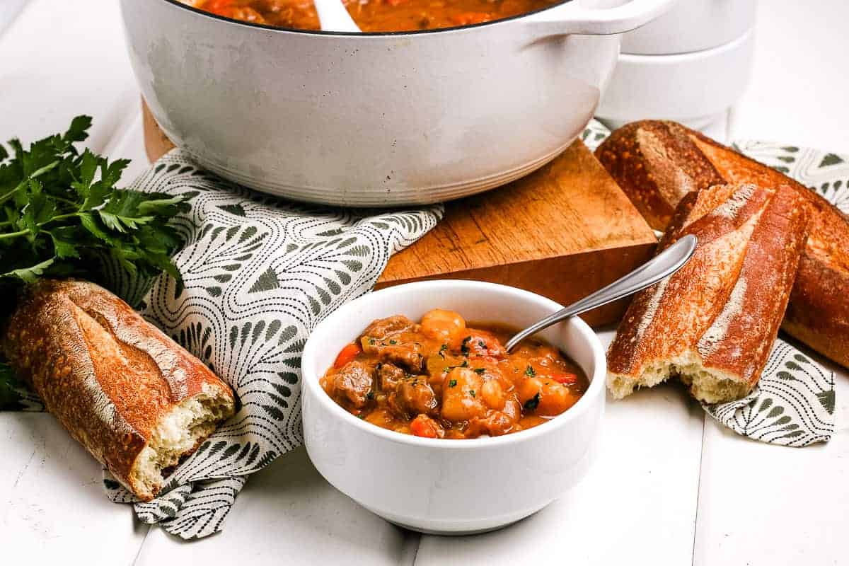 White bowl full of Irish Beef Stew with Spoon in it