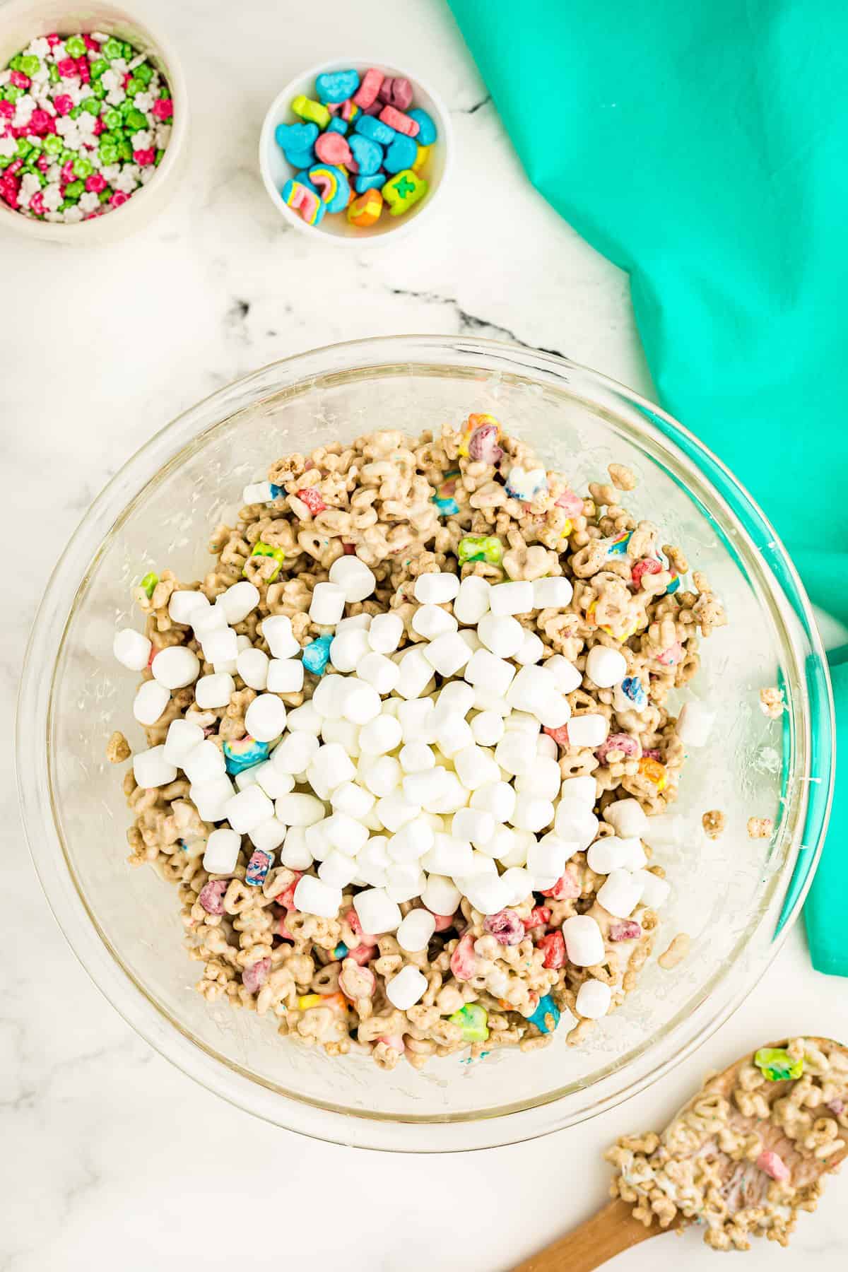 Overhead image of marshmallow and lucky charms mixture with extra mini marshmallows on top