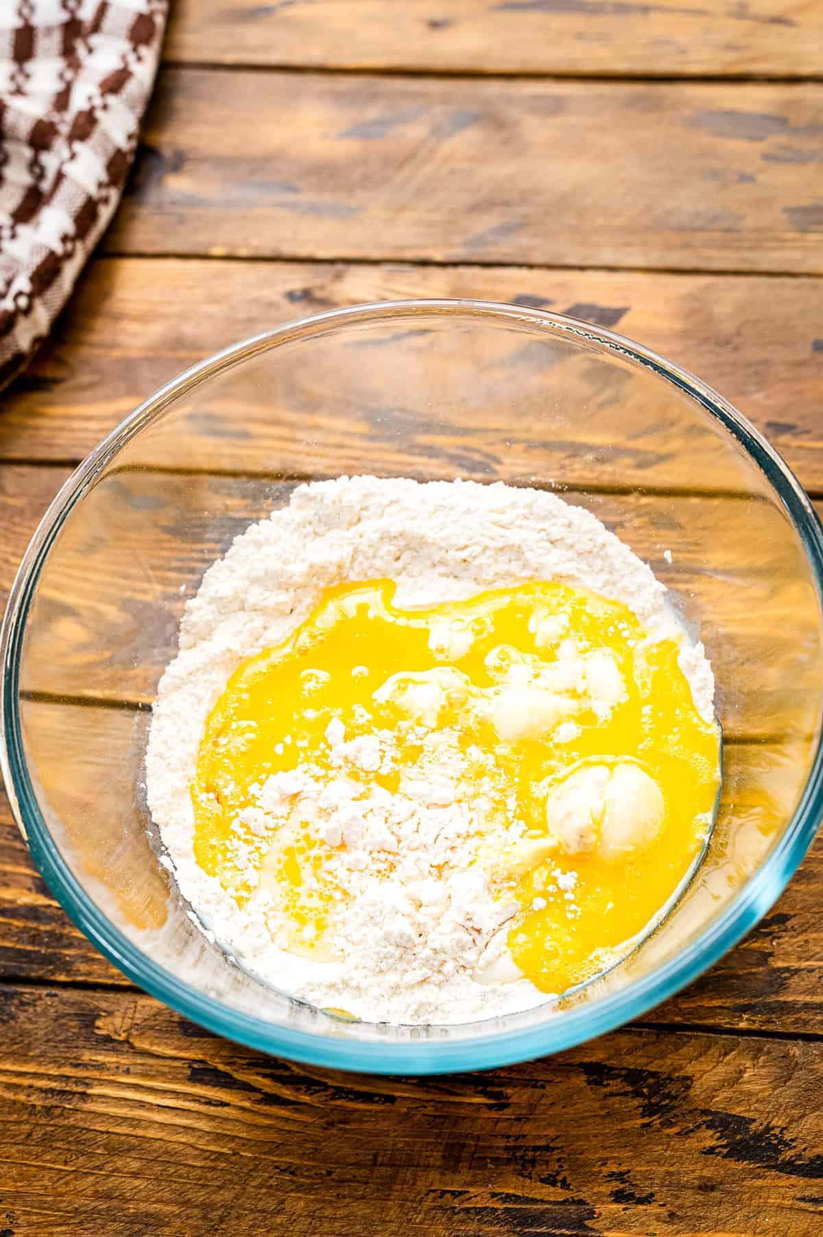 Wet ingredients added to dry in glass bowl for mini pancake cereal