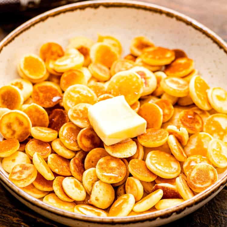 Mini Pancake Cereal in a bowl with a butter slice on top