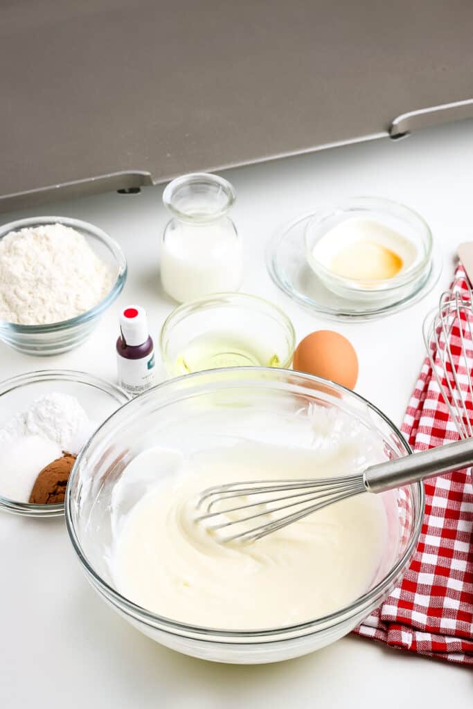 Glass bowl with mixed wet ingredients for pancakes