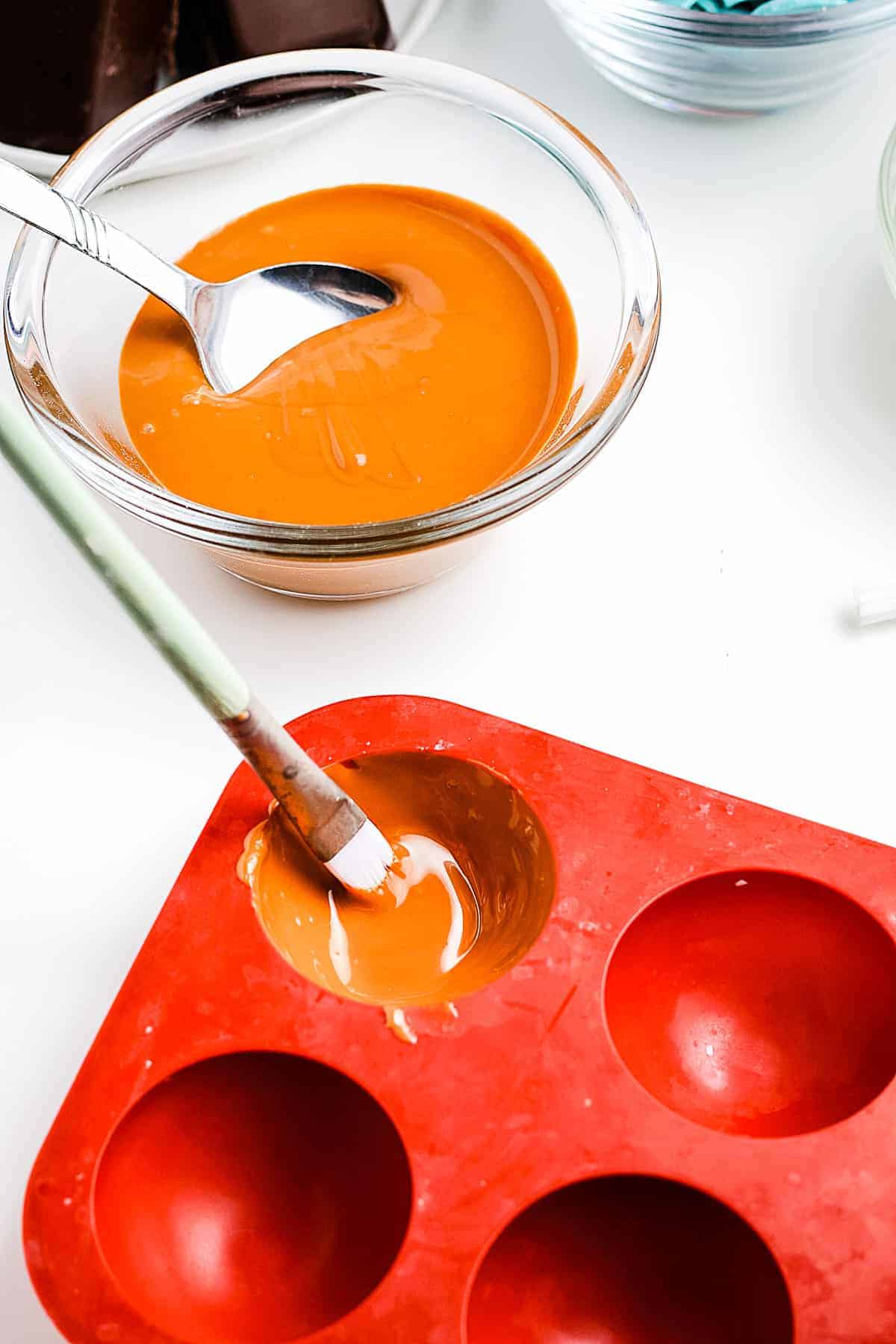 Brushing caramel into silicone molds