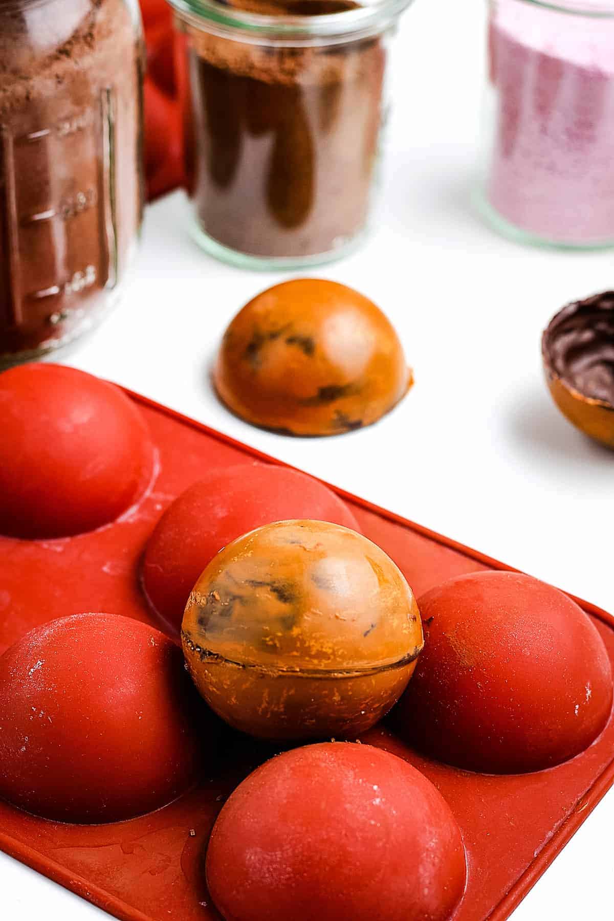 Salted Caramel Hot Cocoa Bombs sitting on silicone mold