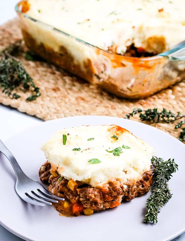 A white plate with a slice of Shepherd's Pie