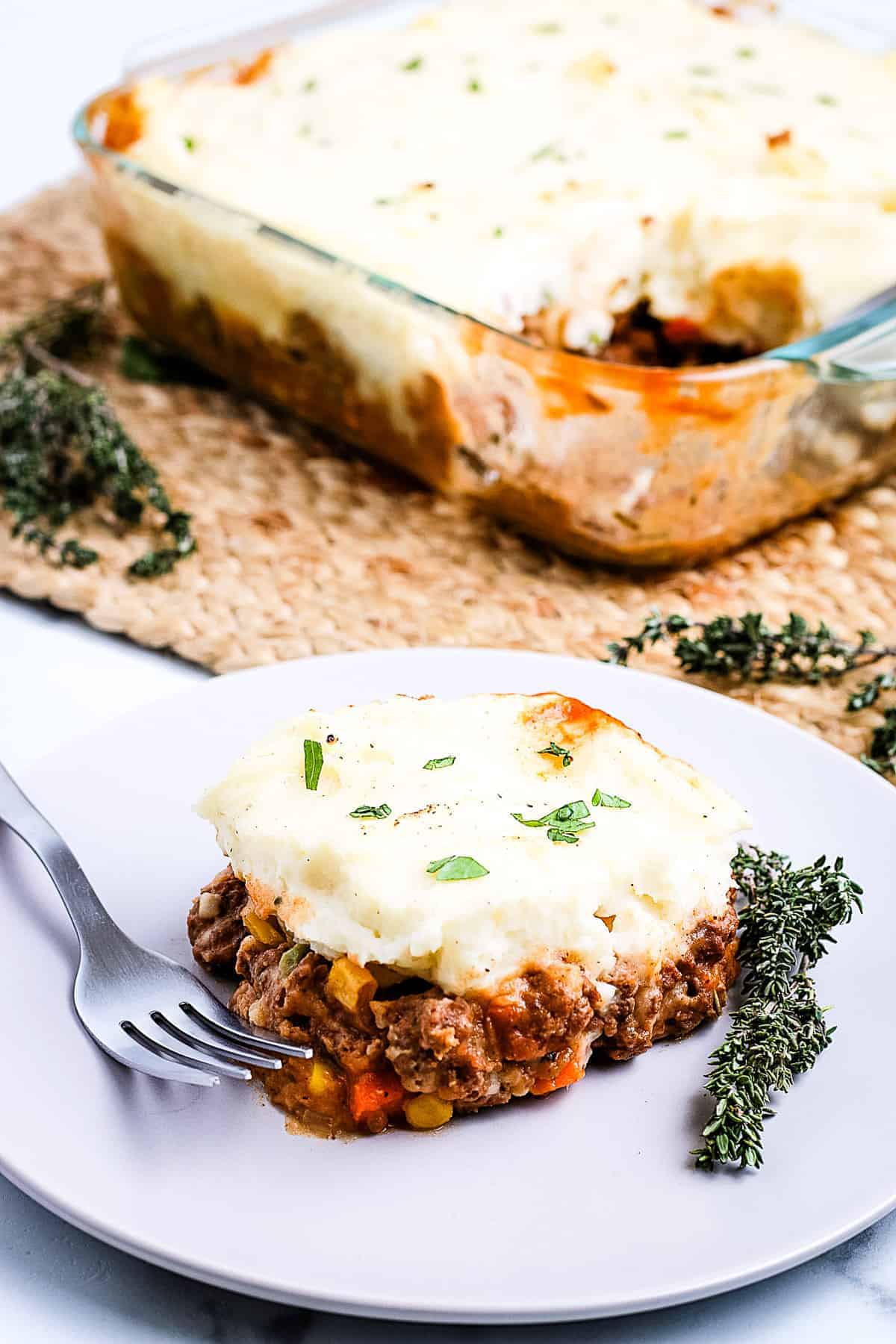 A white plate with a slice of Shepherd's Pie