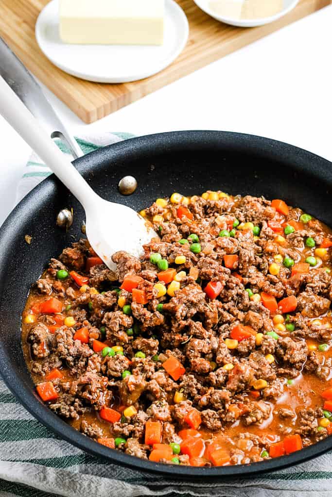 Ground beef mixture stirred in skillet