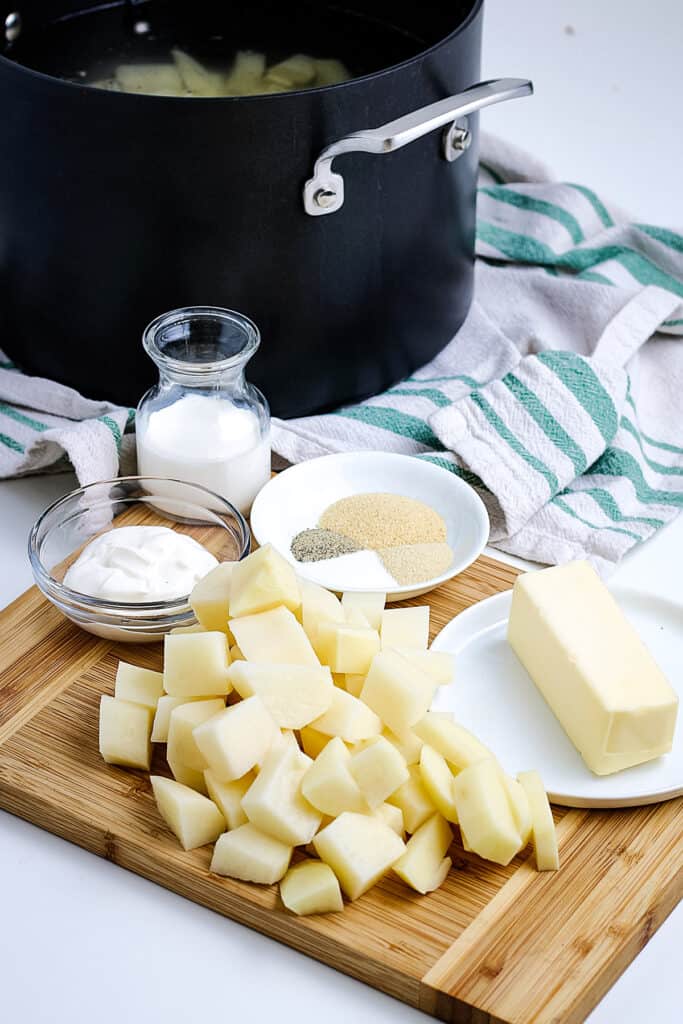 Ingredients to Make mashed potatoes on cutting board