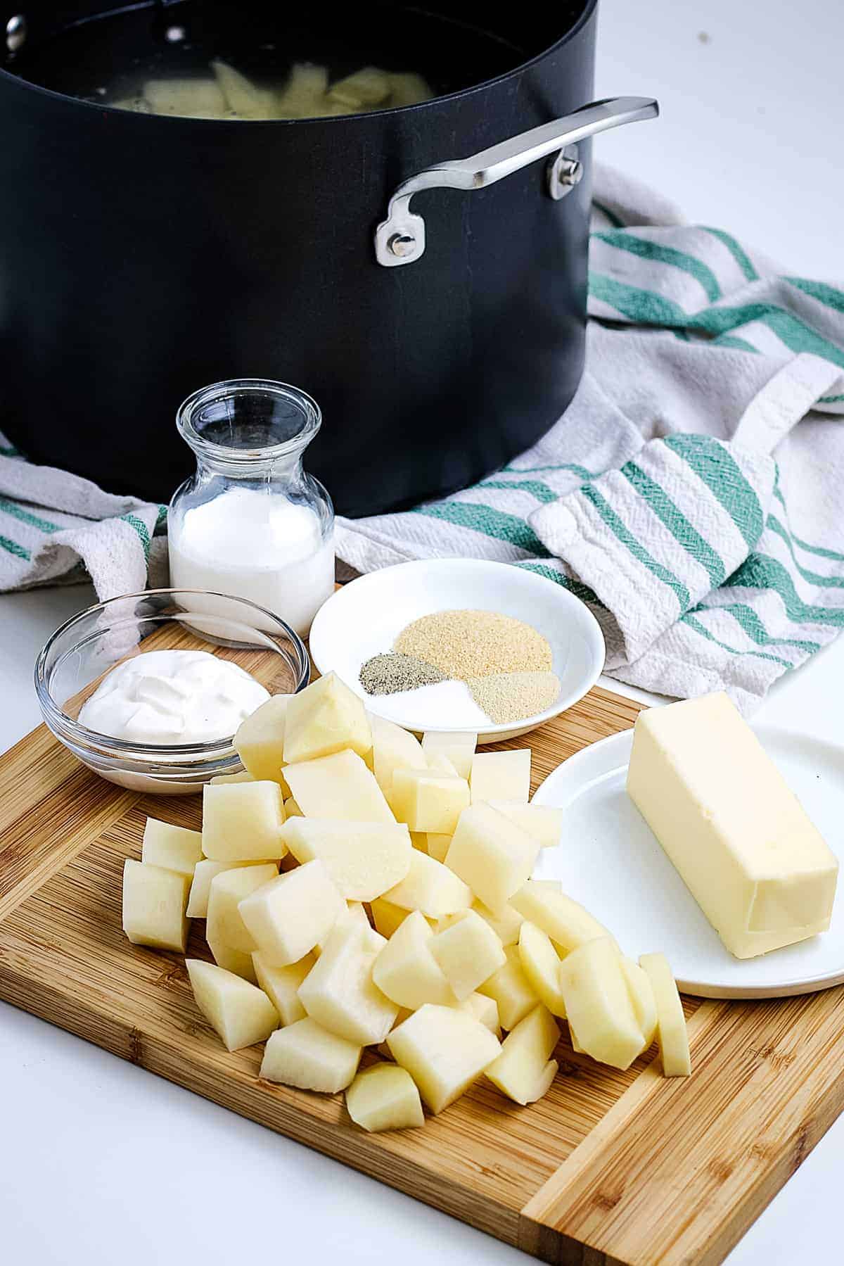 Ingredients to Make mashed potatoes on cutting board