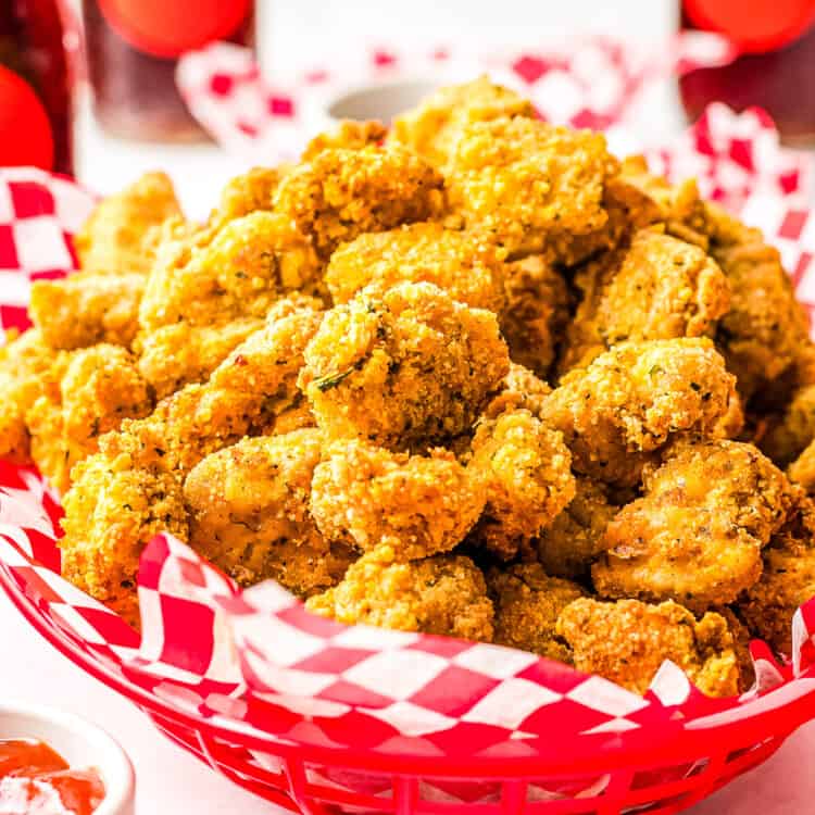 Red basket with red and white checkered paper and Air Fryer Chicken Nuggets in it