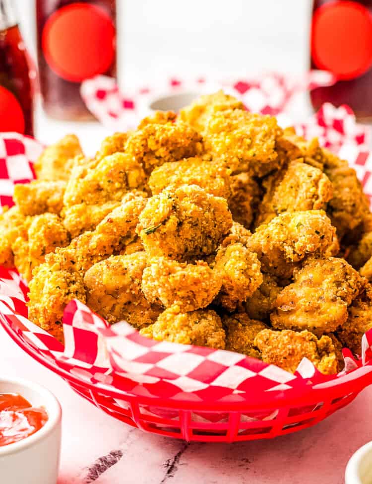 Red basket with red and white checkered paper and Air Fryer Chicken Nuggets in it