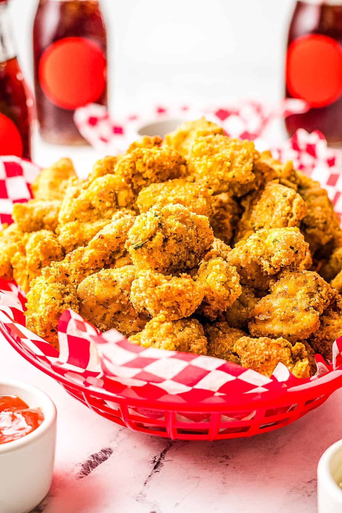 Red basket with red and white checkered paper and Air Fryer Chicken Nuggets in it