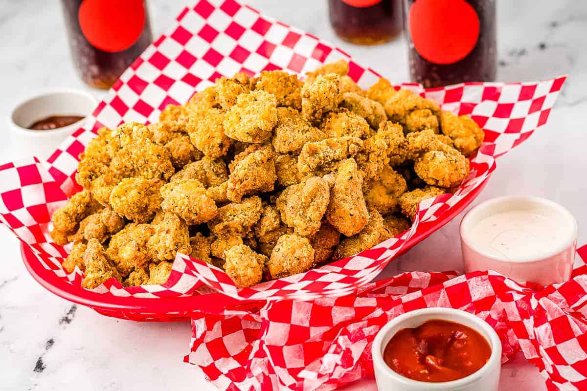 Basket of breaded chicken nuggets in red basket