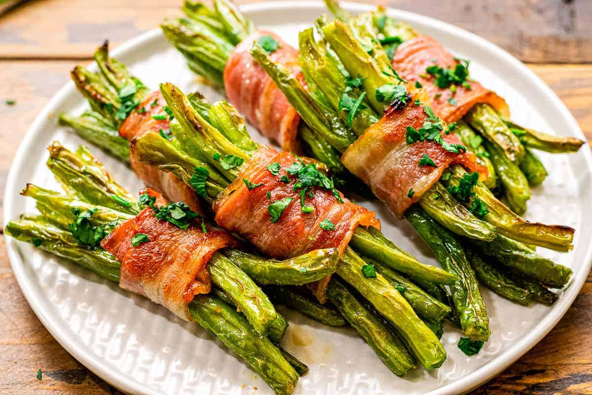 White plate with green bean bundles on it