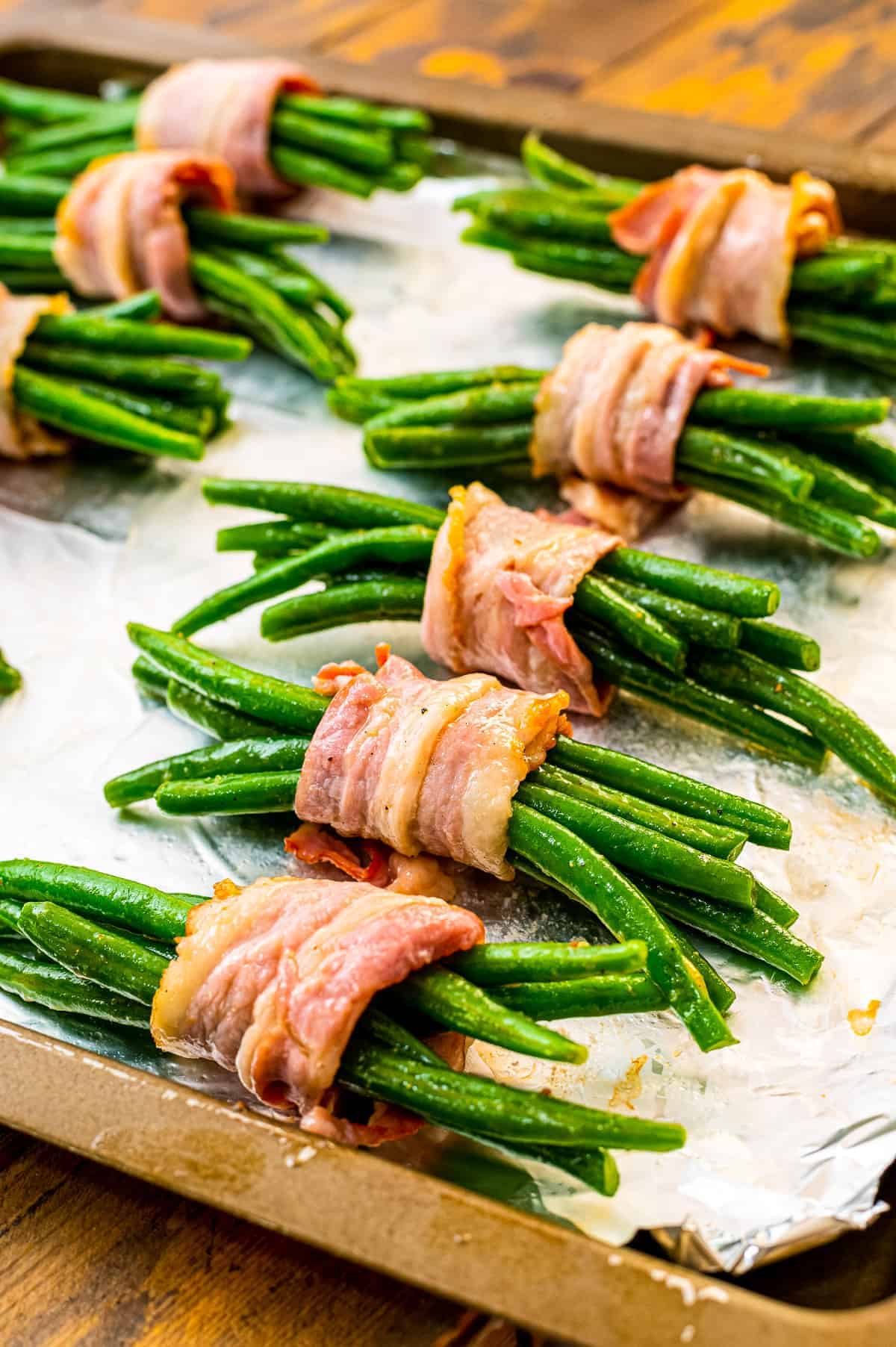 Green Bean Bundles on a sheet pan lined with foil before baking