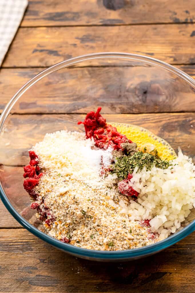 Glass bowl with ingredients for baked meatballs